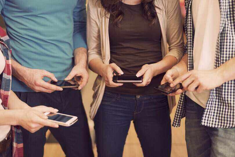 Close up of people with contemporary mobile phones ignoring life around them.jpg