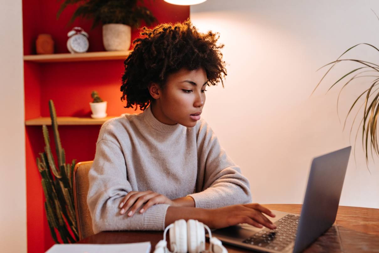 Woman in sweater is working intently on her content optimization checklist